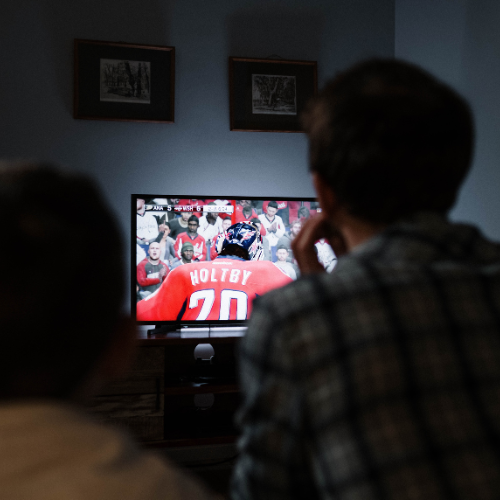 Family watching TV together at home